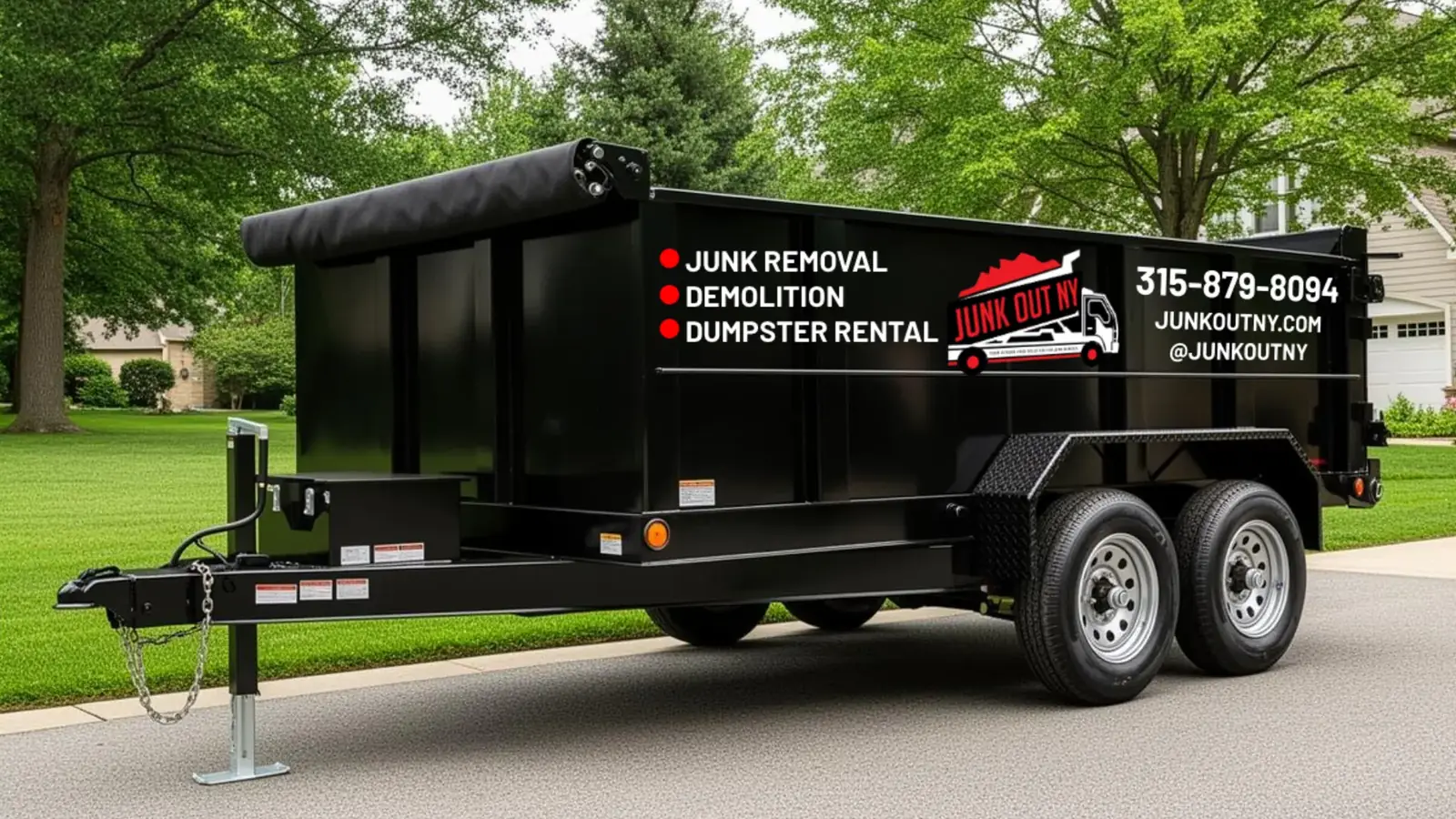 Black 15-yard dump trailer parked in a suburban driveway, Junk Out NY junk removal and dumpster rental in Rochester NY